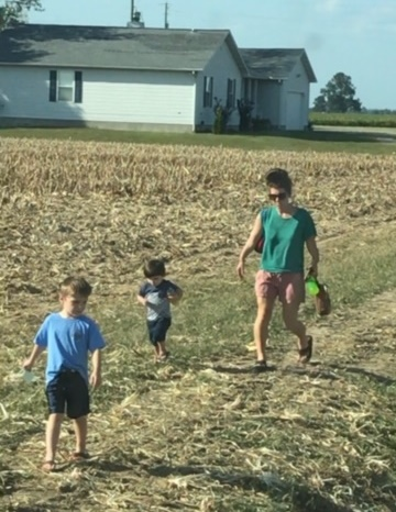 a woman and two children are walking